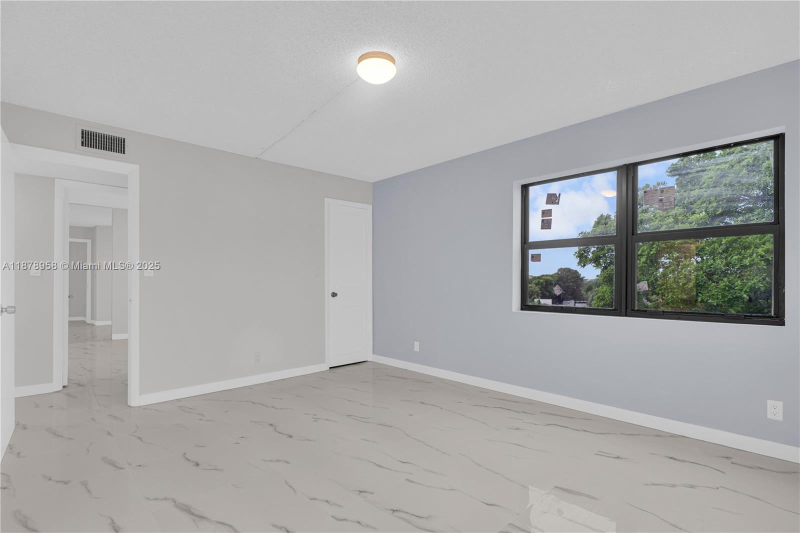 9355 Southwest 8th Street, Unit 425 Boca Raton, FL 33428 - Photo 17 of 42 an empty room with windows