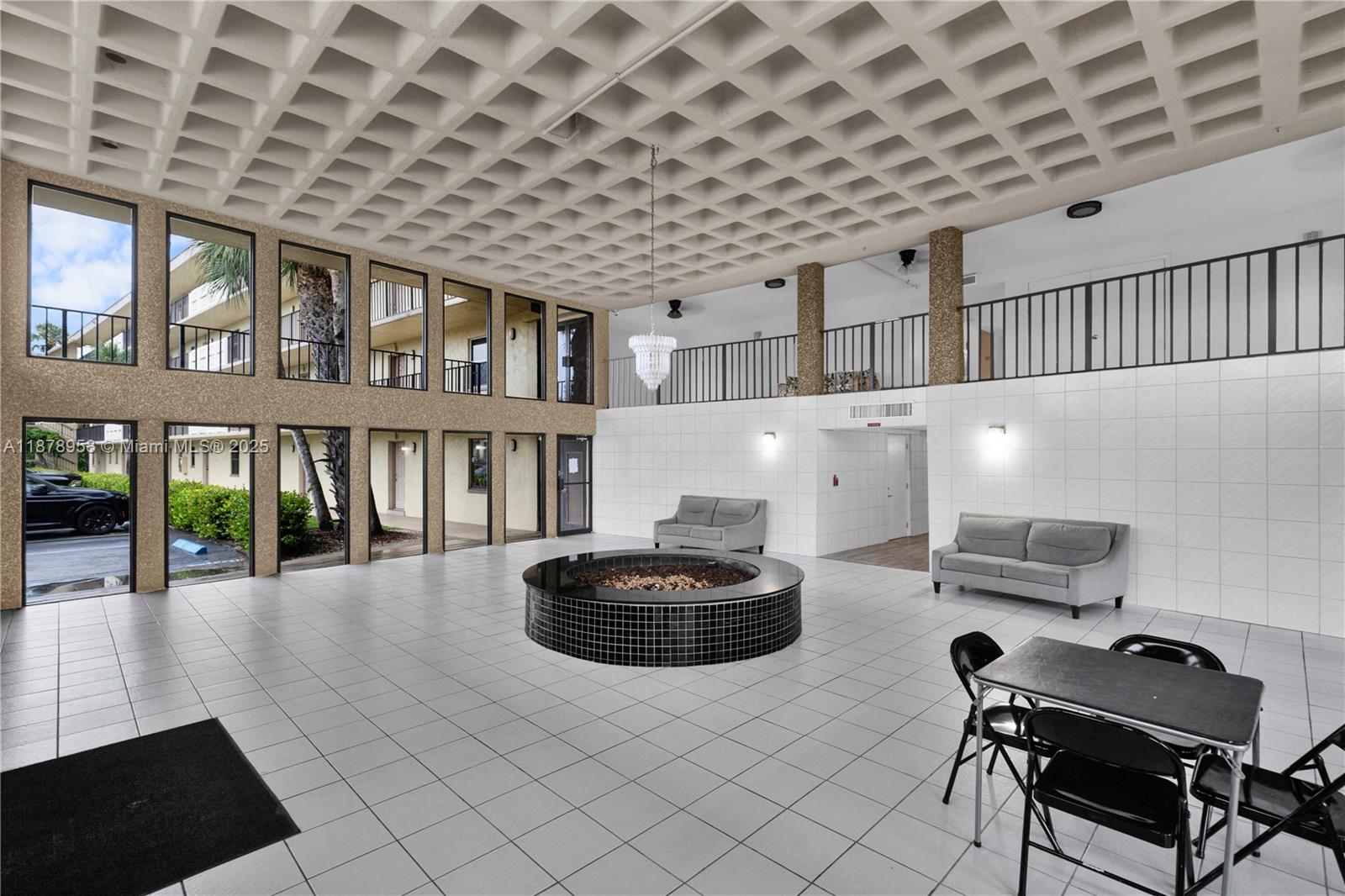 9355 Southwest 8th Street, Unit 425 Boca Raton, FL 33428 - Photo 27 of 42 a room with furniture and a book shelf