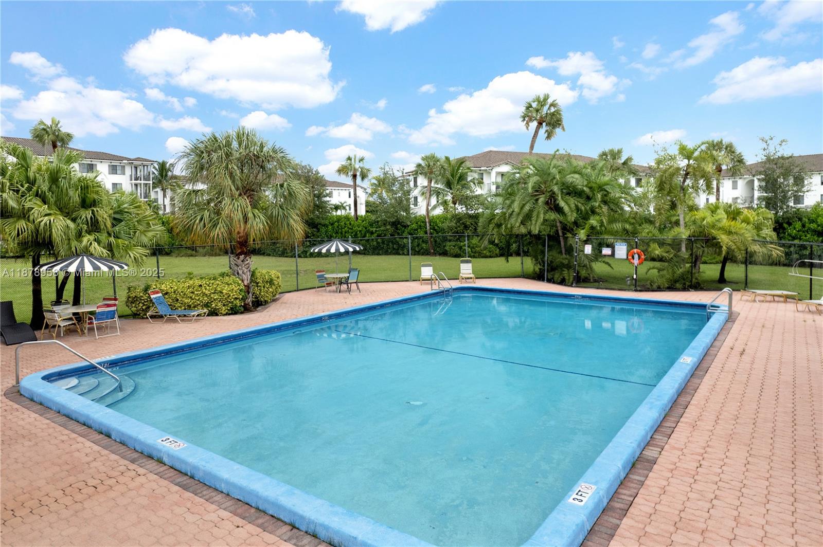 9355 Southwest 8th Street, Unit 425 Boca Raton, FL 33428 - Photo 30 of 42 a view of a backyard with a large pool and large trees