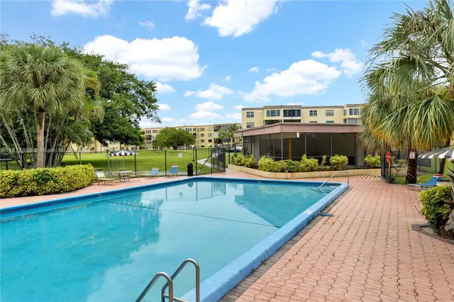 a view of a swimming pool with a garden and plants