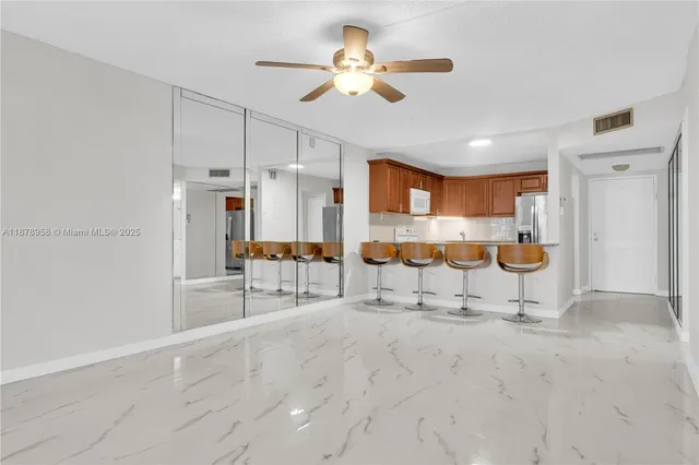 a view of kitchen with refrigerator cabinets and a ceiling fan