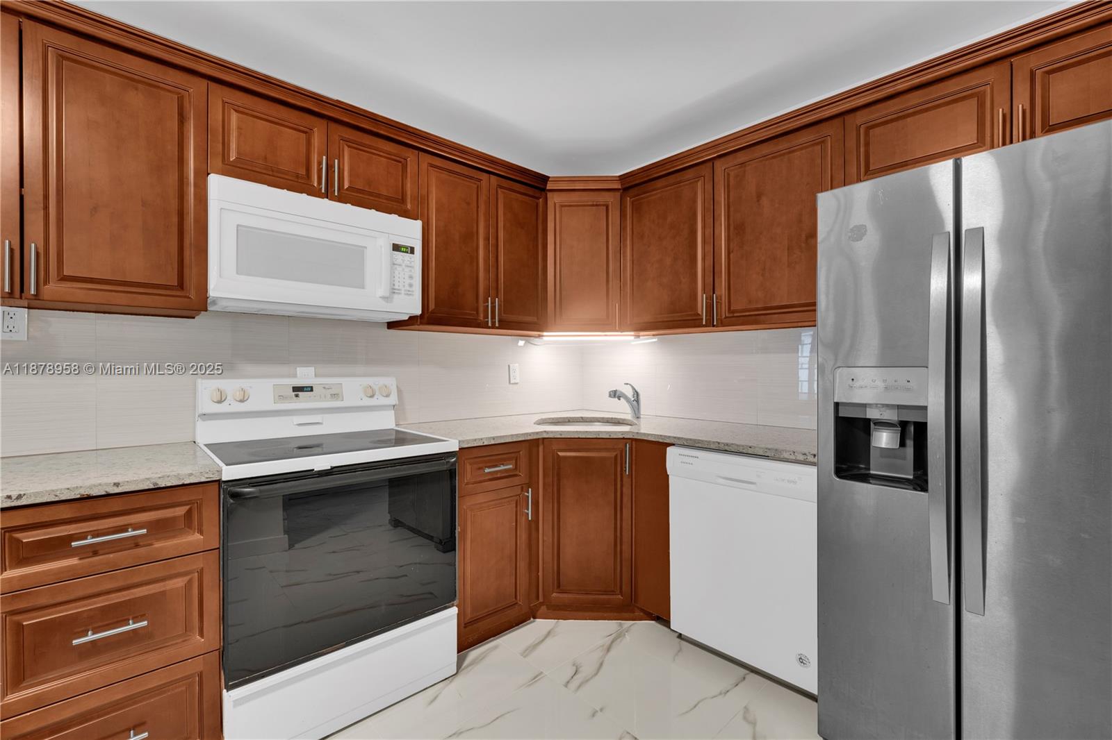 9355 Southwest 8th Street, Unit 425 Boca Raton, FL 33428 - Photo 8 of 42 a kitchen with stainless steel appliances granite countertop a refrigerator sink and cabinets