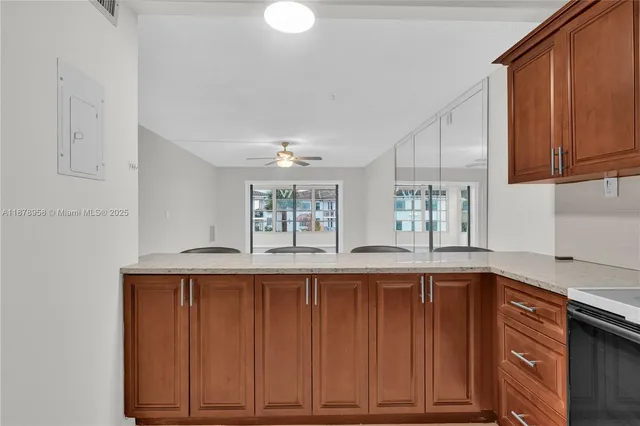 a kitchen with stainless steel appliances granite countertop wooden cabinets a sink and dishwasher