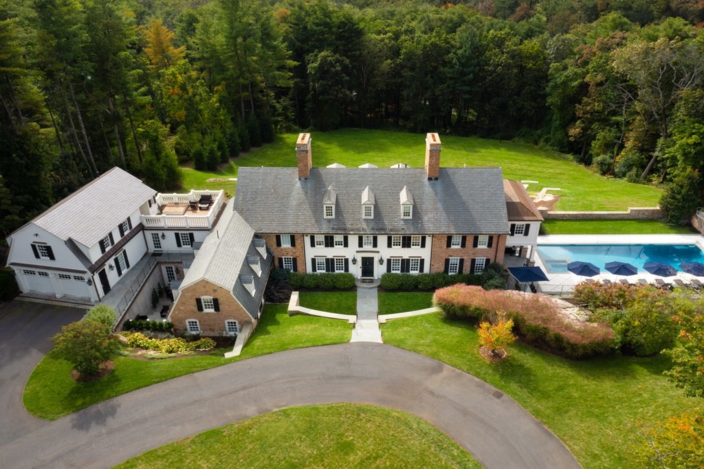 an aerial view of a house with a garden and swimming pool