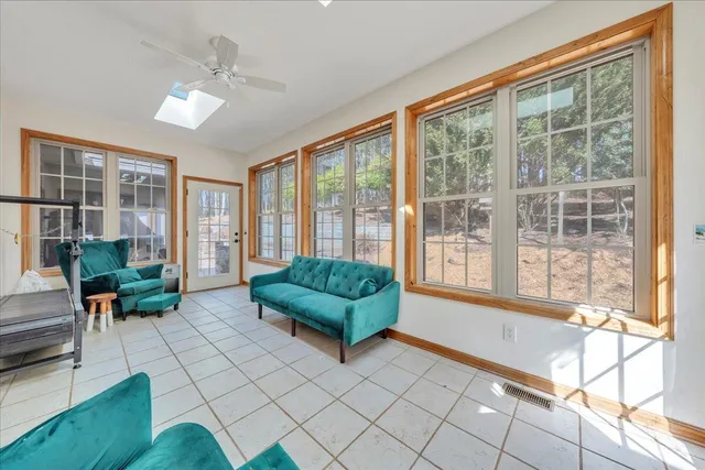 a living room with a bed and dressers