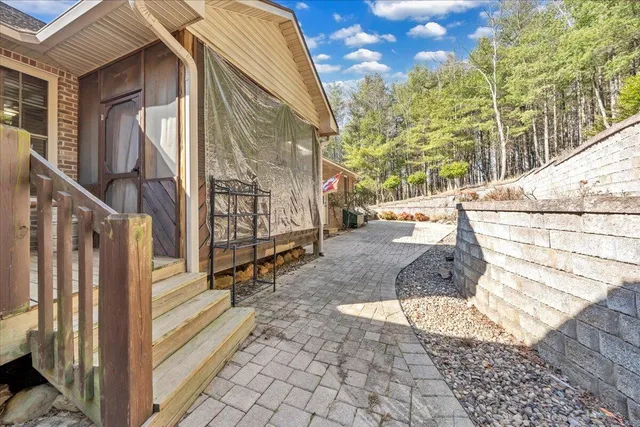 a view of a house with a yard and large tree