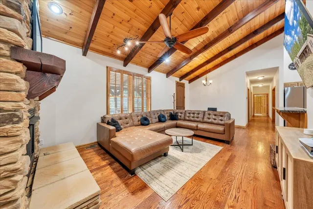 a kitchen with stainless steel appliances granite countertop a stove a sink dishwasher and a refrigerator with white cabinets