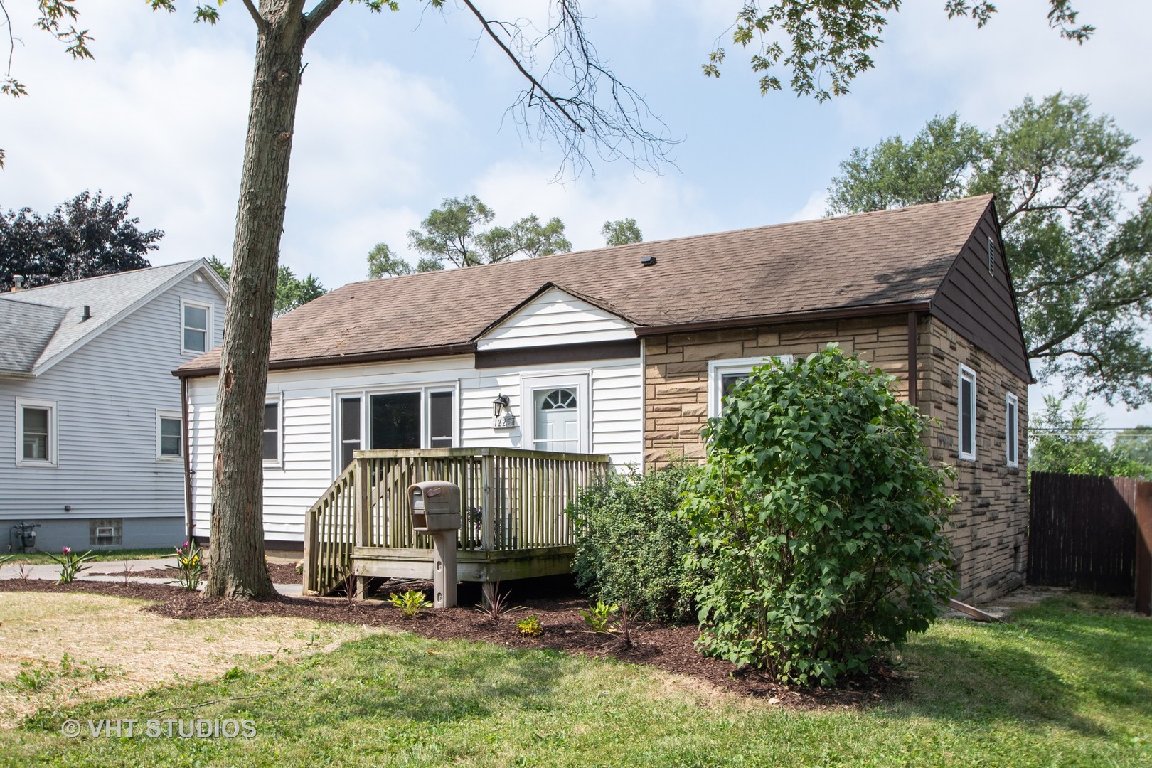 1225 Cleveland Street Lockport, IL 60441 - Photo 16 of 17 a view of a house with a yard plants and large tree