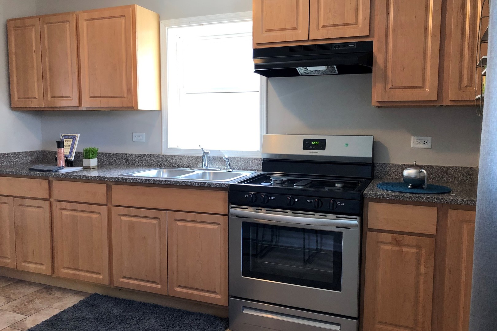 1225 Cleveland Street Lockport, IL 60441 - Photo 5 of 17 a kitchen with granite countertop cabinets stainless steel appliances and a sink