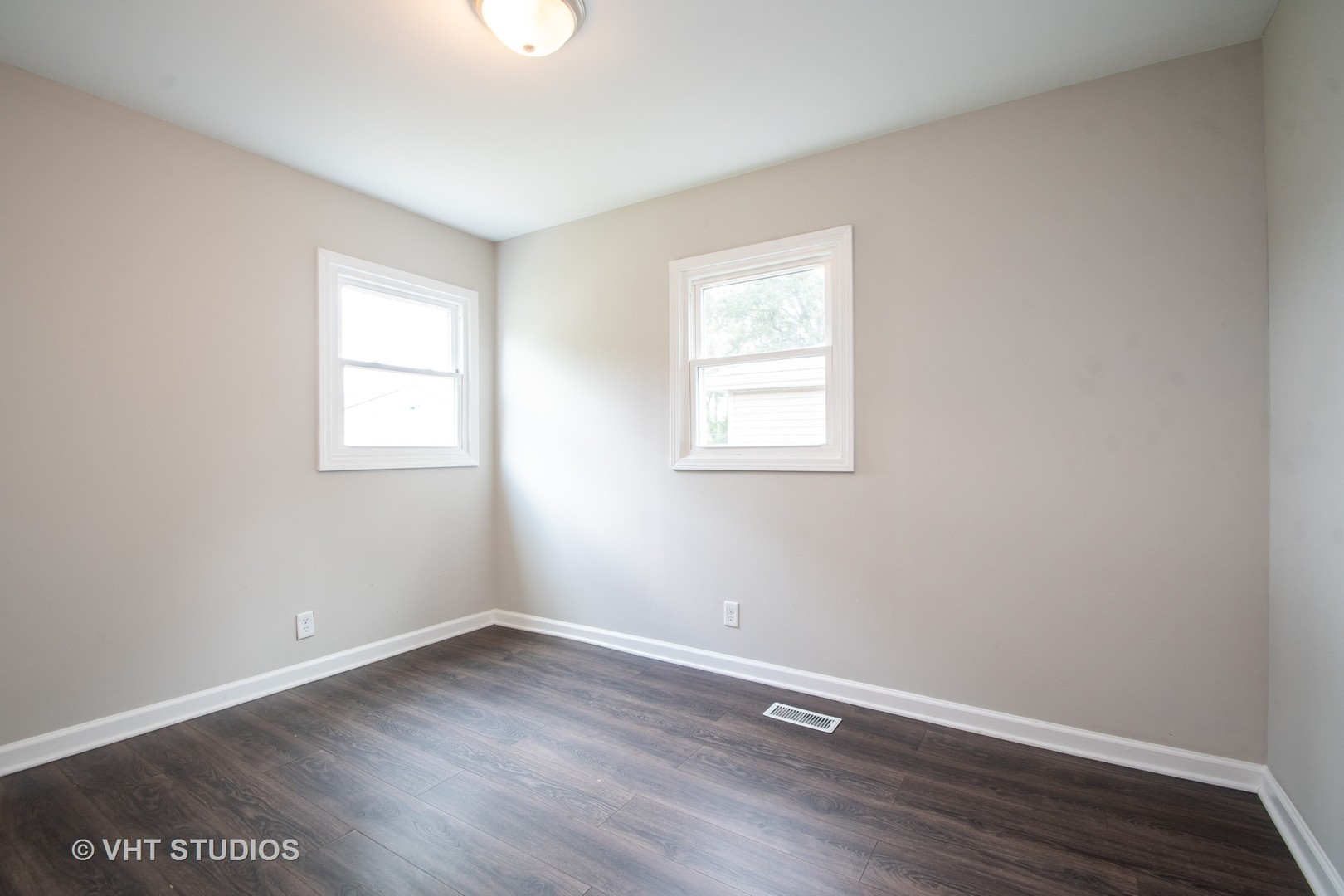 1225 Cleveland Street Lockport, IL 60441 - Photo 9 of 17 an empty room with wooden floor and windows