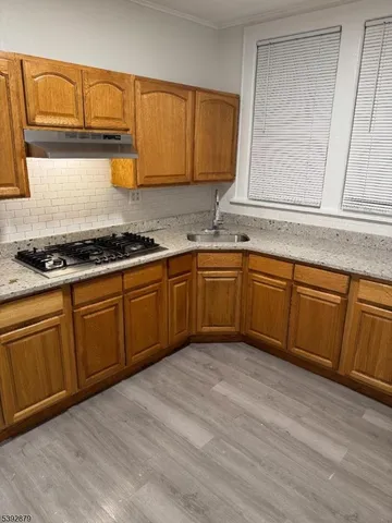 a kitchen with stainless steel appliances granite countertop a sink stove and cabinets
