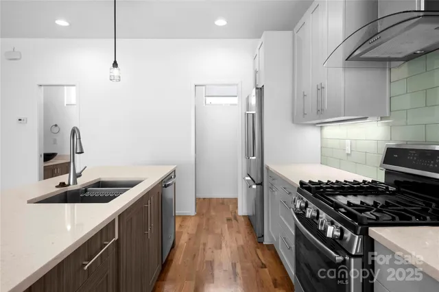 a kitchen with a stove sink and a refrigerator