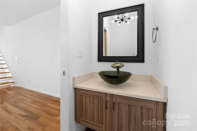 a kitchen with stainless steel appliances kitchen island granite countertop a sink and white cabinets