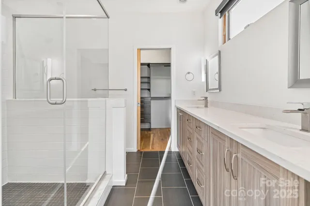 a bathroom with a double vanity sink and a mirror