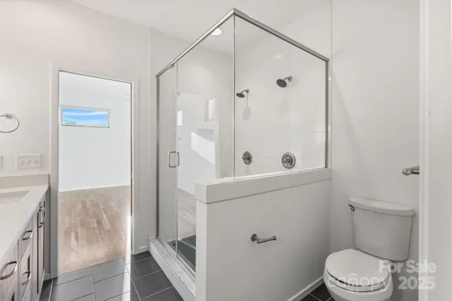 a spacious bathroom with a sink a mirror and a shower