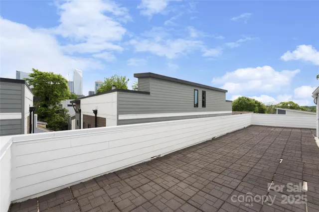 a view of a city that has tall buildings and a big yard