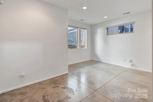 an empty room with closet and a bathroom