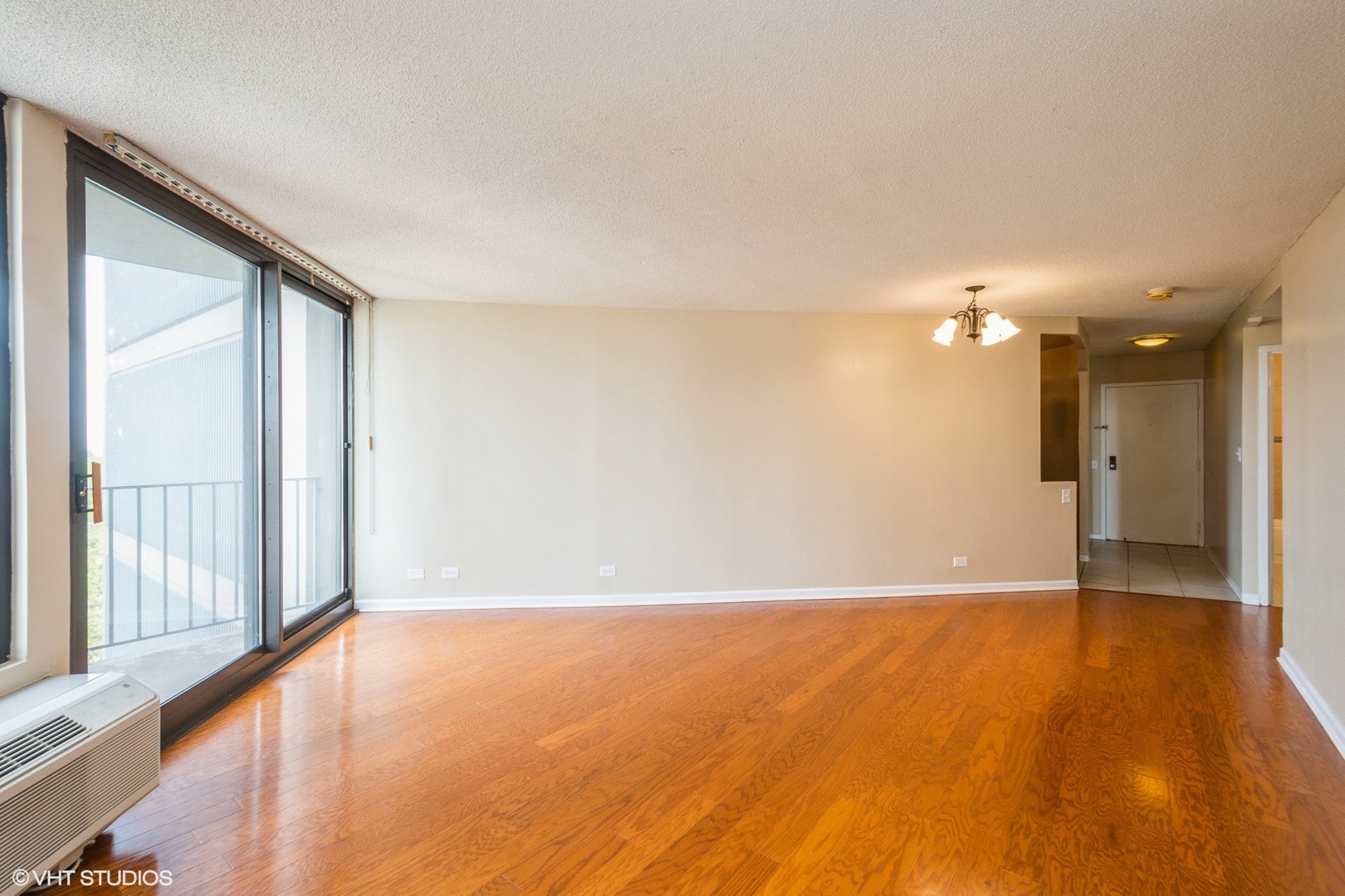 5320 North Sheridan Road, Unit 608 Chicago, IL 60640 - Photo 2 of 10 a view of an empty room with wooden floor and a window