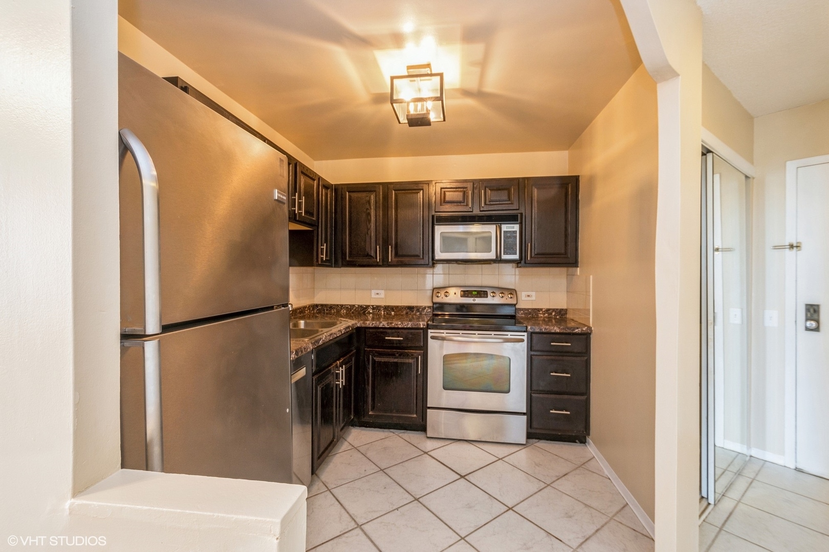 5320 North Sheridan Road, Unit 608 Chicago, IL 60640 - Photo 3 of 10 a kitchen with stainless steel appliances granite countertop a refrigerator sink and stove