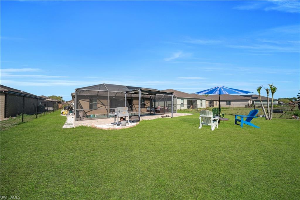 175 Shadowview Court Lehigh Acres, FL 33974 - Photo 13 of 39 a view of a house with backyard porch and sitting area