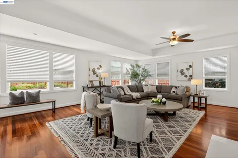 a living room with fireplace furniture and a wooden floor