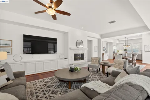a living room with furniture a flat screen tv and a fireplace