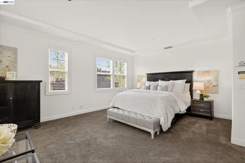 a bed sitting in a bedroom next to a window