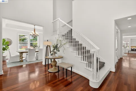 a view of entryway with wooden floor and dining room