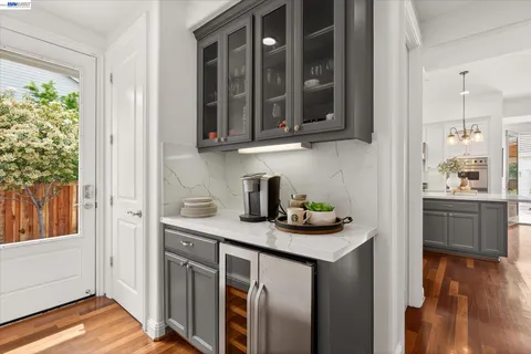 a kitchen with stainless steel appliances granite countertop a sink and a stove with wooden floor