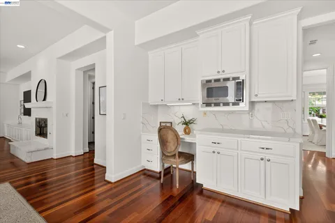 a view of kitchen with wooden floor and electronic appliances