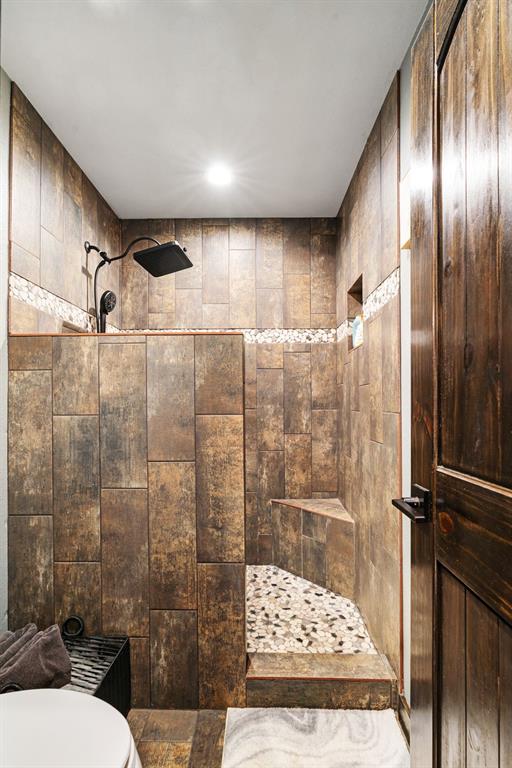 962 County Road Pattonville, TX 75468 - Photo 22 of 37 a bathroom with a shower and a toilet