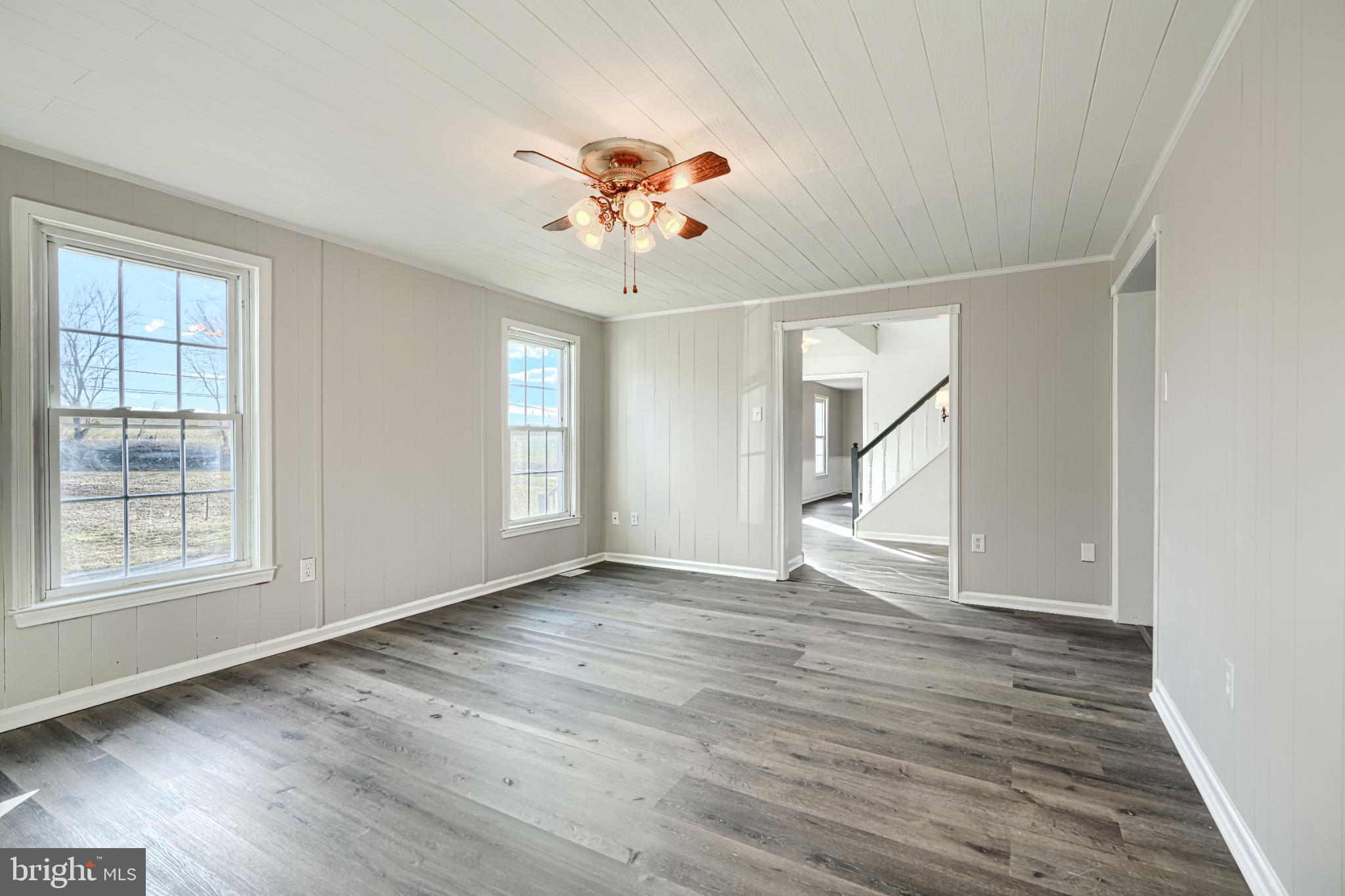 1216 Bachmans Valley Road Westminster, MD 21158 - Photo 12 of 70 a view of an empty room with wooden floor and a window