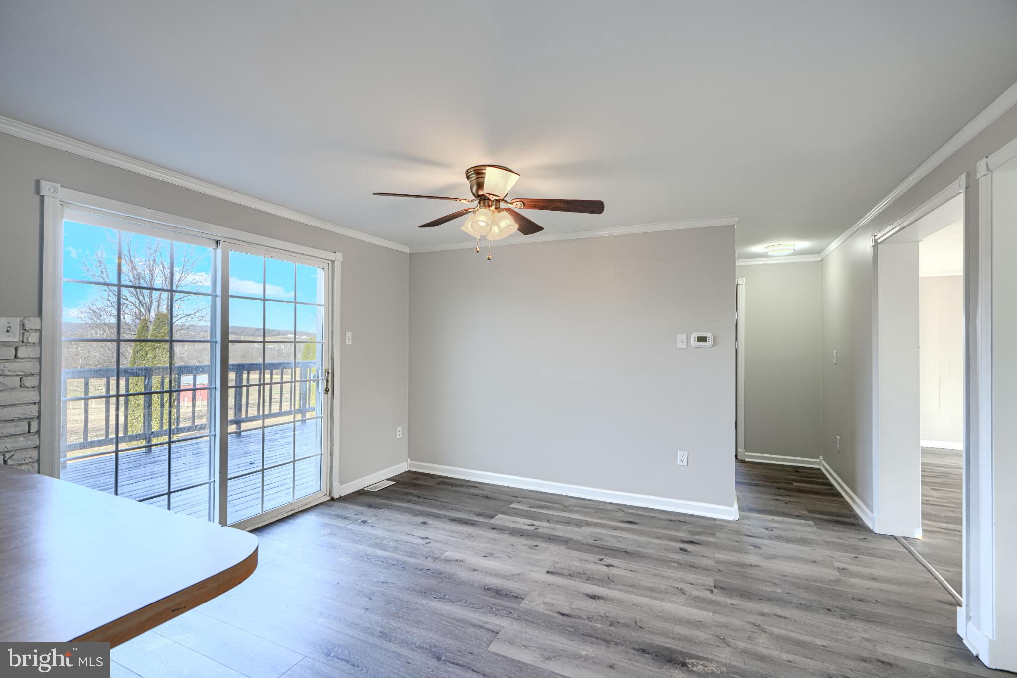 1216 Bachmans Valley Road Westminster, MD 21158 - Photo 13 of 70 an empty room with wooden floor fan and windows