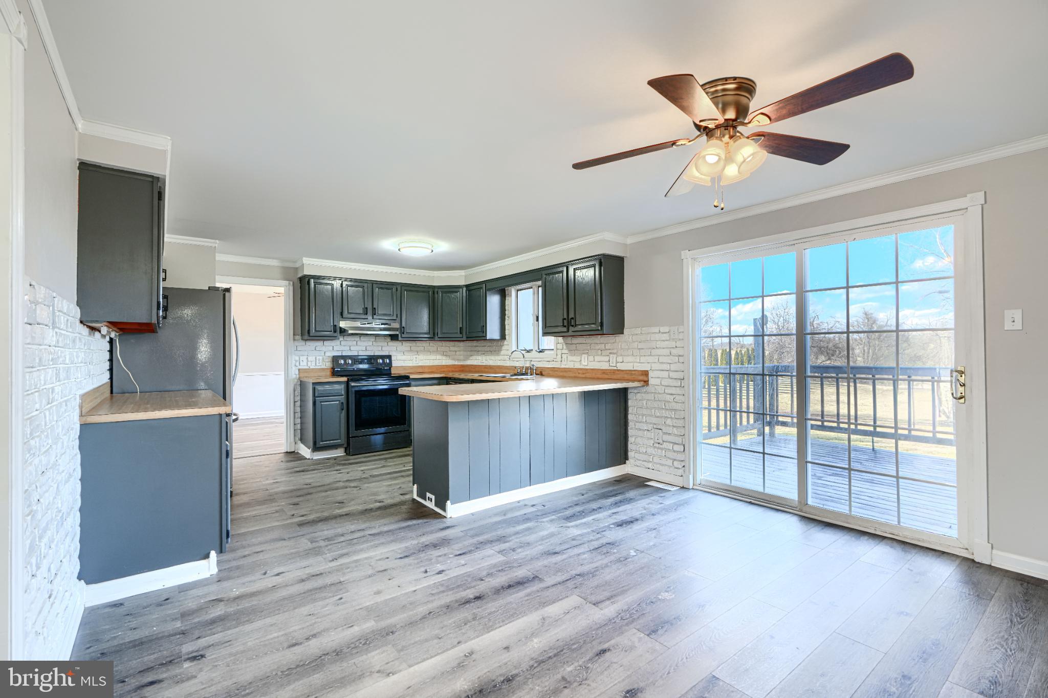 1216 Bachmans Valley Road Westminster, MD 21158 - Photo 16 of 70 a large kitchen with a large counter top a sink stainless steel appliances and cabinets