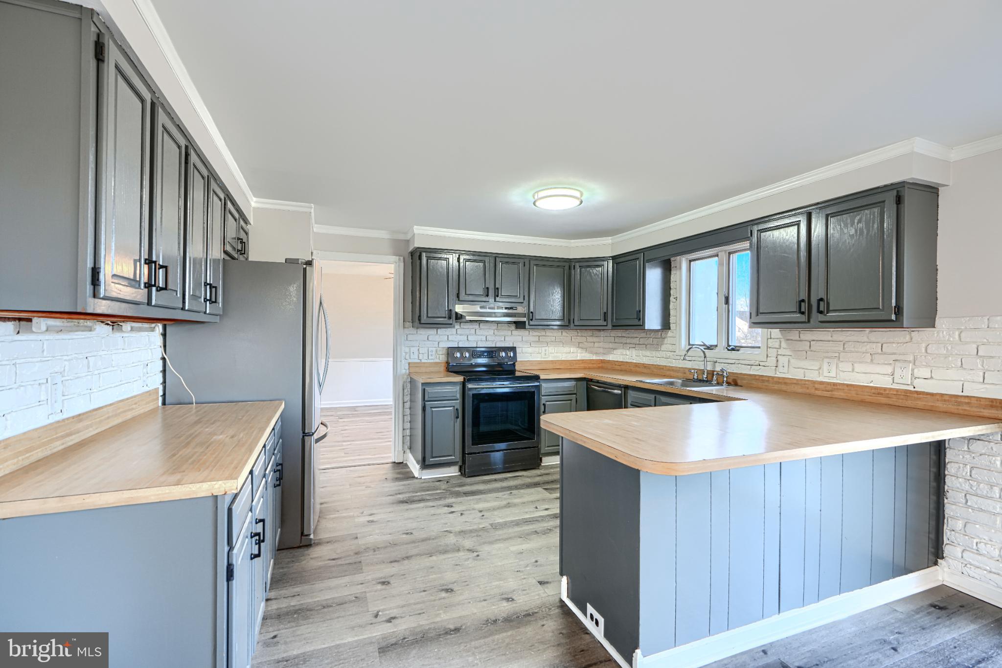 1216 Bachmans Valley Road Westminster, MD 21158 - Photo 17 of 70 a kitchen with stainless steel appliances granite countertop a sink stove and refrigerator