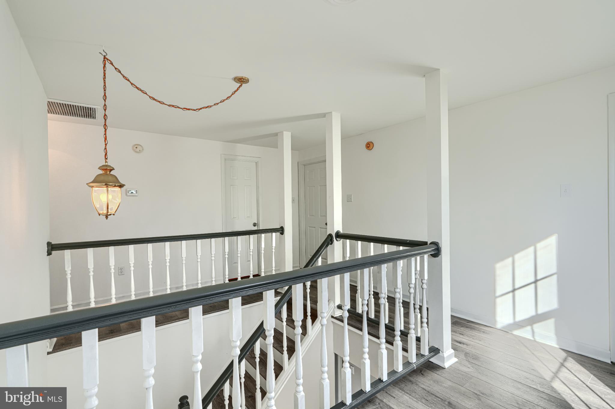 1216 Bachmans Valley Road Westminster, MD 21158 - Photo 26 of 70 a view of staircase with railing and a chandelier