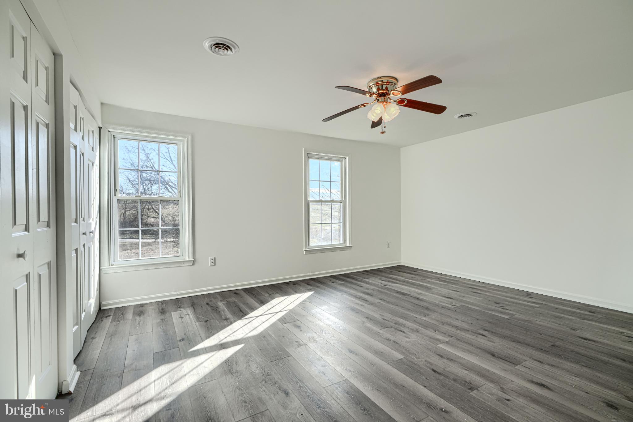 1216 Bachmans Valley Road Westminster, MD 21158 - Photo 29 of 70 a view of empty room with wooden floor and fan