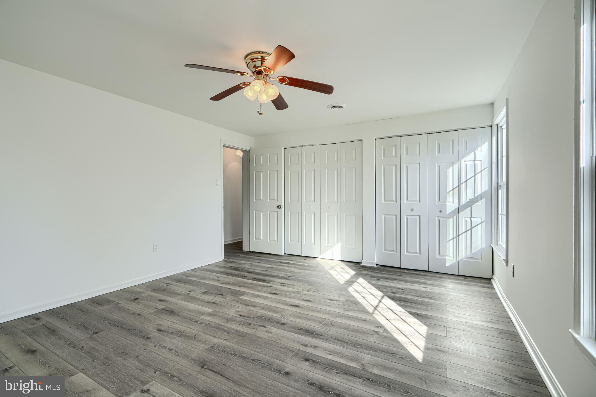 1216 Bachmans Valley Road Westminster, MD 21158 - Photo 30 of 70 a view of an empty room with wooden floor and a window