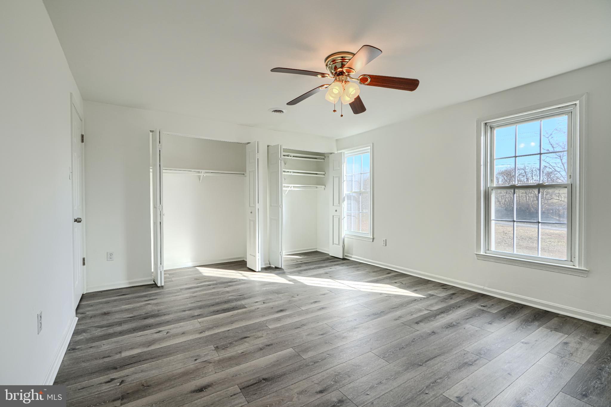 1216 Bachmans Valley Road Westminster, MD 21158 - Photo 31 of 70 a view of an empty room with wooden floor and window