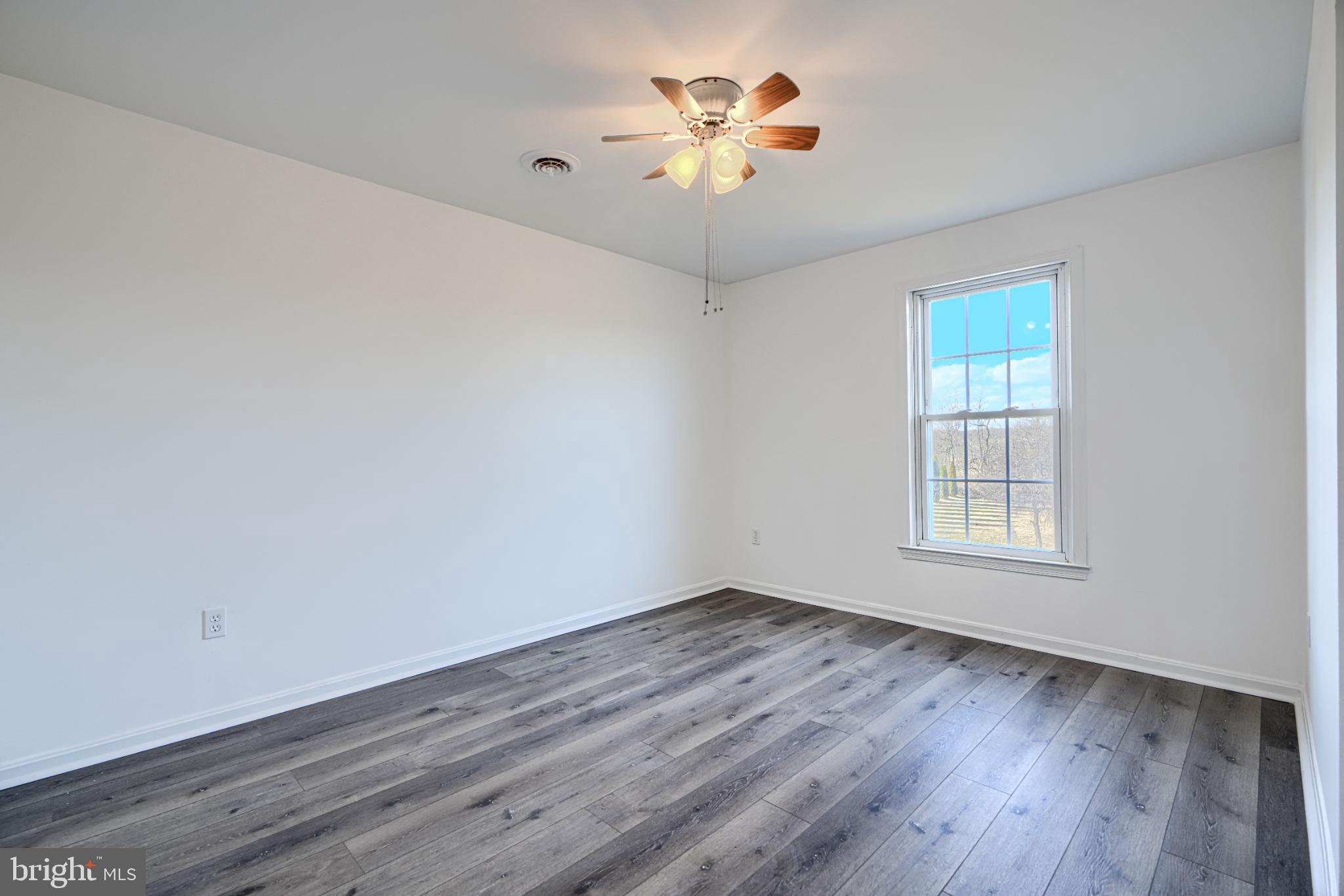 1216 Bachmans Valley Road Westminster, MD 21158 - Photo 32 of 70 wooden floor in an empty room with a window