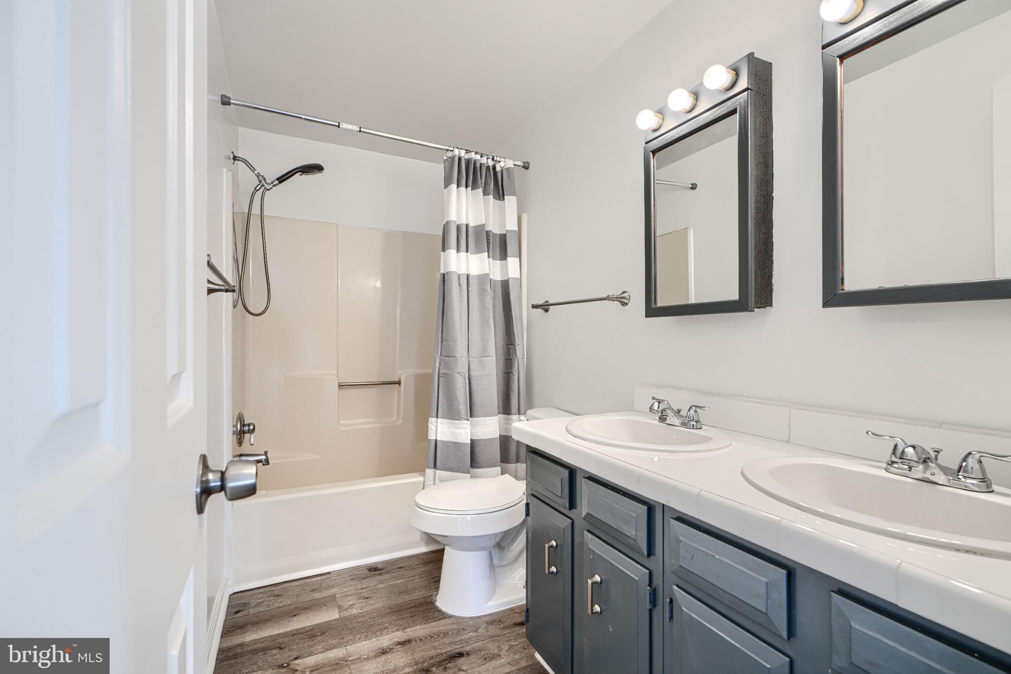 1216 Bachmans Valley Road Westminster, MD 21158 - Photo 42 of 70 a bathroom with a granite countertop sink toilet and shower