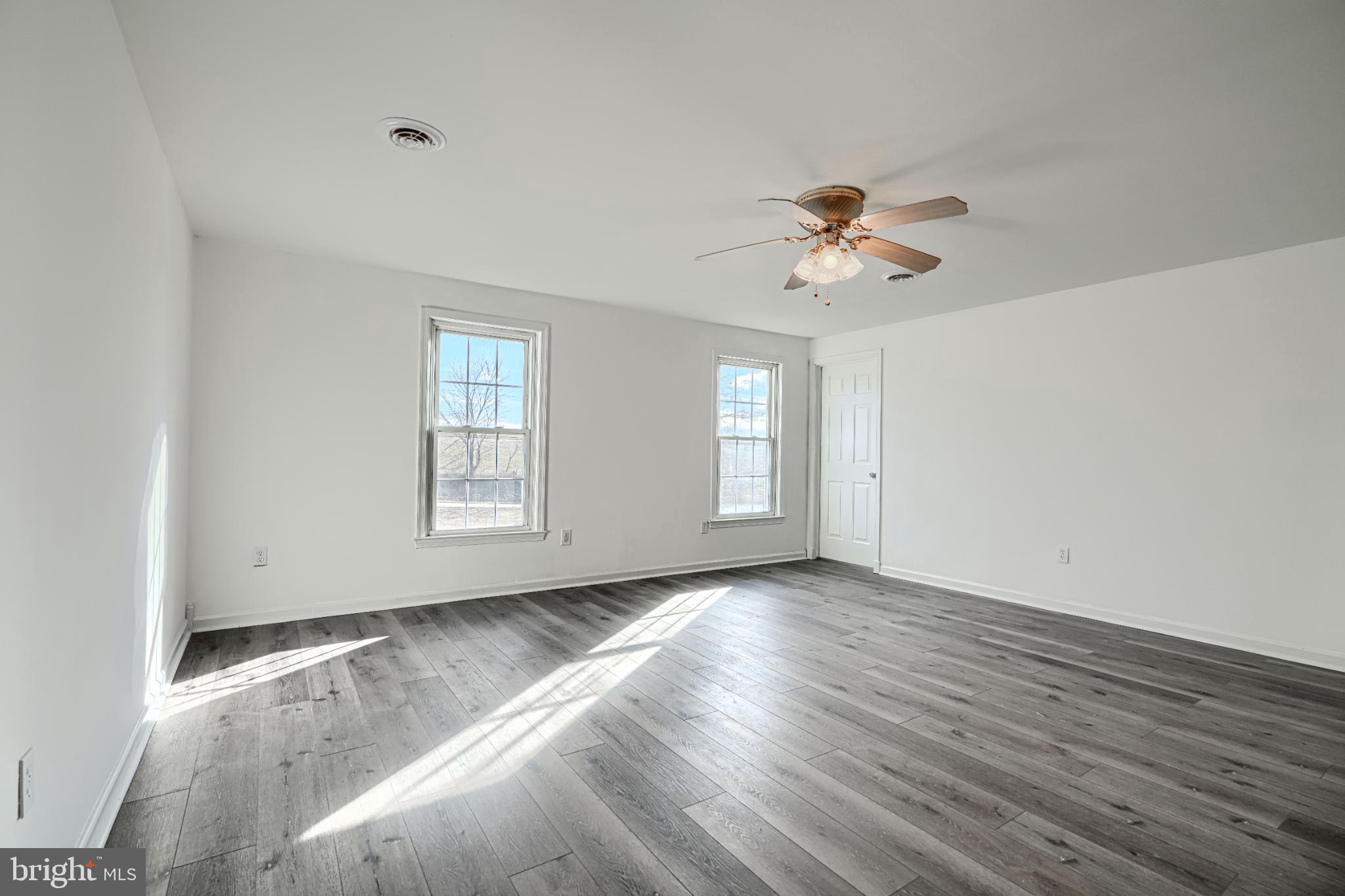 1216 Bachmans Valley Road Westminster, MD 21158 - Photo 45 of 70 wooden floor in an empty room with a window