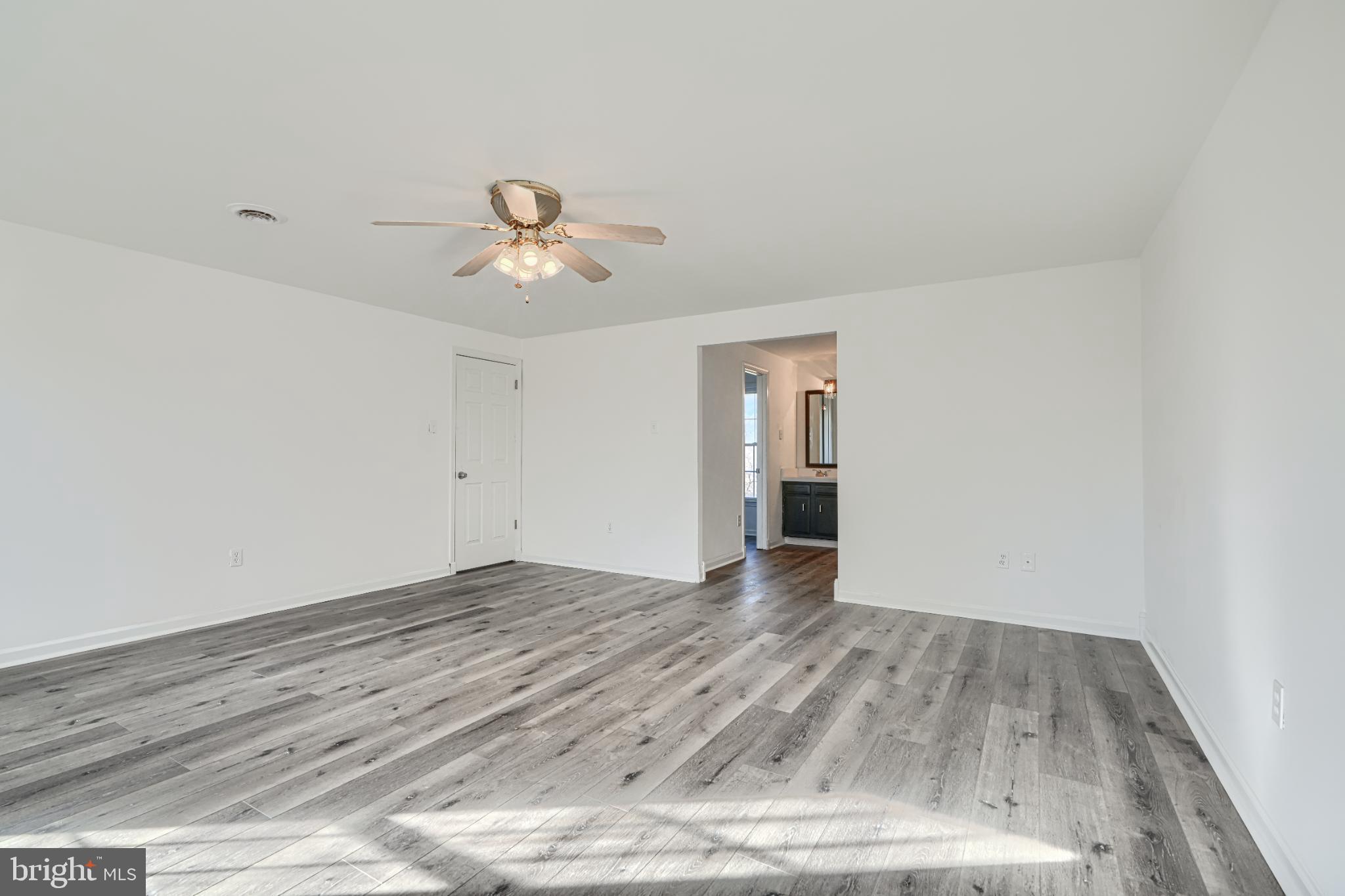 1216 Bachmans Valley Road Westminster, MD 21158 - Photo 46 of 70 a view of empty room with wooden floor and ceiling fan