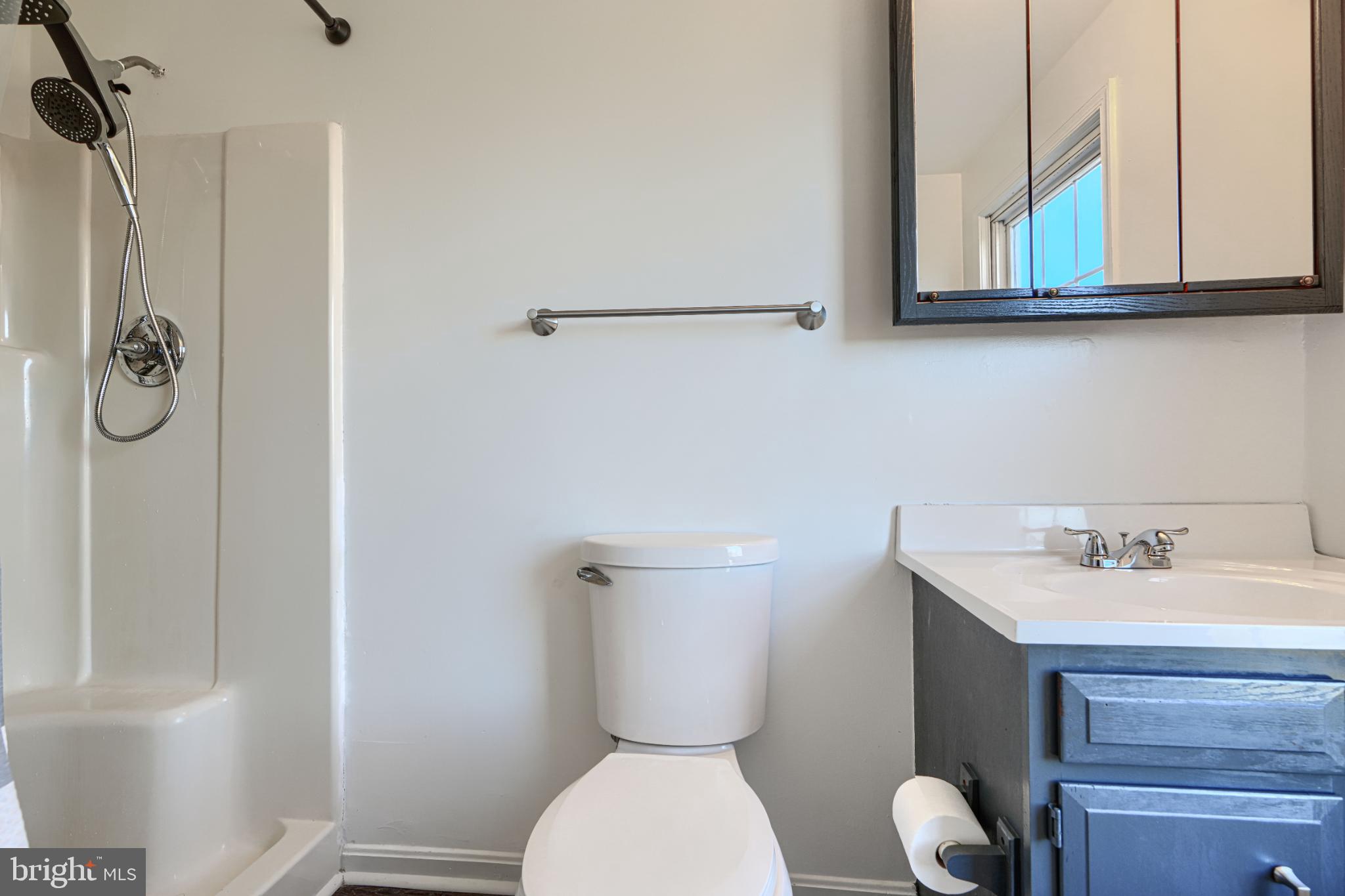 1216 Bachmans Valley Road Westminster, MD 21158 - Photo 51 of 70 a bathroom with a toilet sink and mirror
