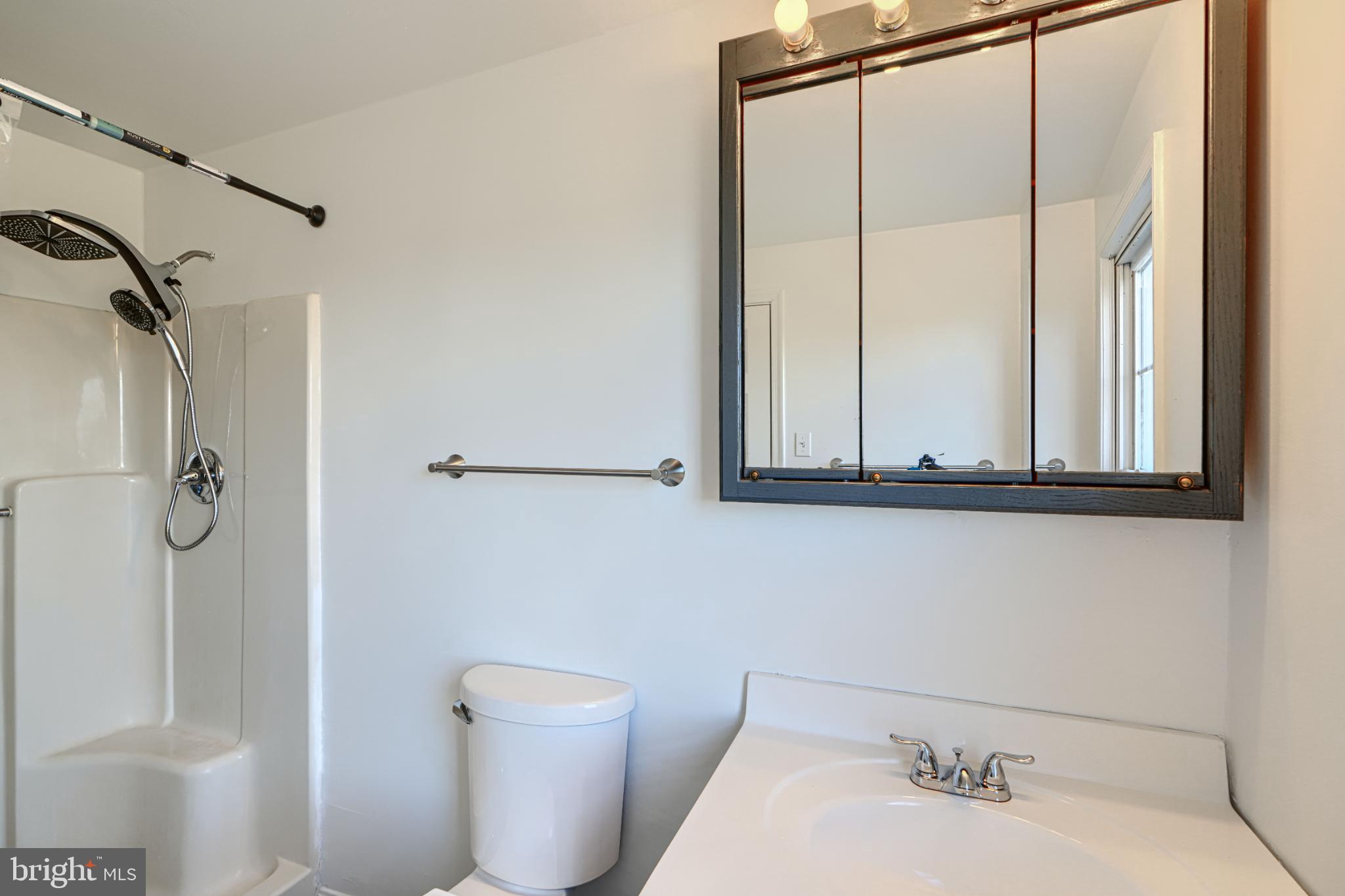 1216 Bachmans Valley Road Westminster, MD 21158 - Photo 52 of 70 a bathroom with a sink and mirror with toilet