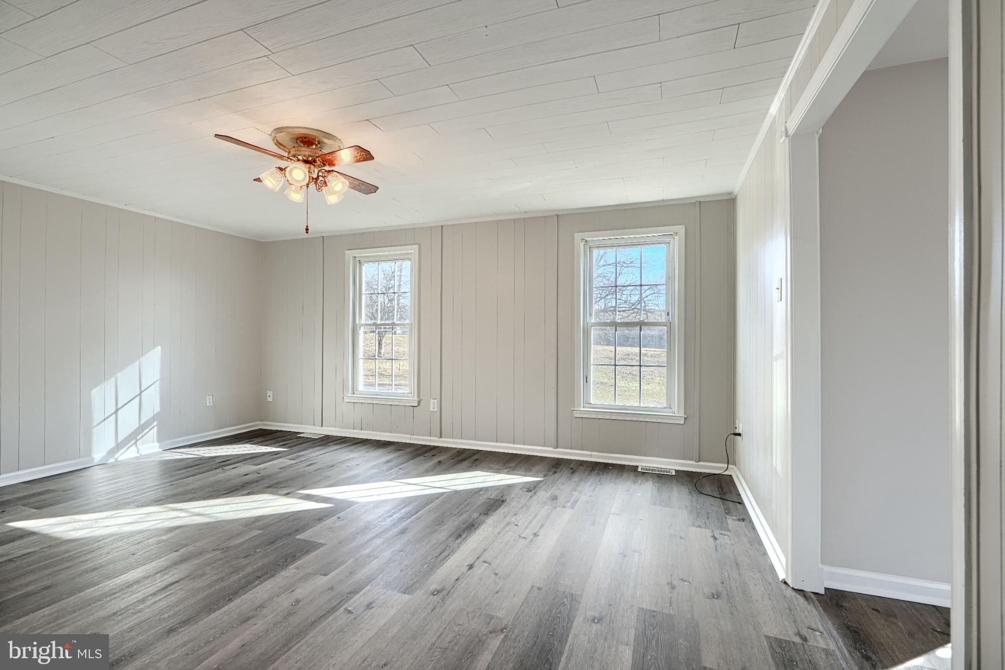 1216 Bachmans Valley Road Westminster, MD 21158 - Photo 10 of 70 an empty room with wooden floor and windows
