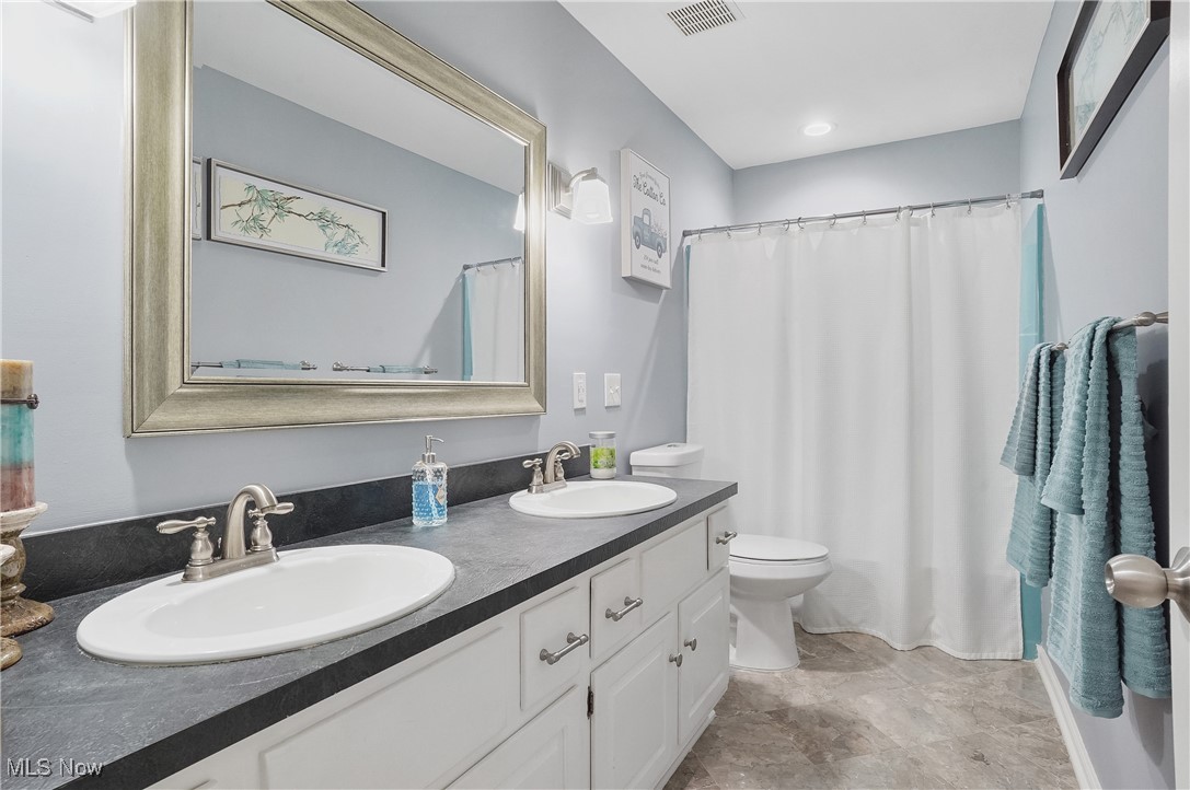 2070 Ridgewood Road Akron, OH 44313 - Photo 32 of 48 Bathroom with vanity, toilet, and a shower with curtain