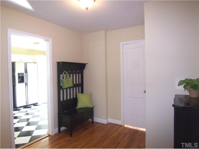 104 West Whitaker Mill Road Raleigh, NC 27608 - Photo 12 of 25 a view of a hallway with wooden floor and a living room