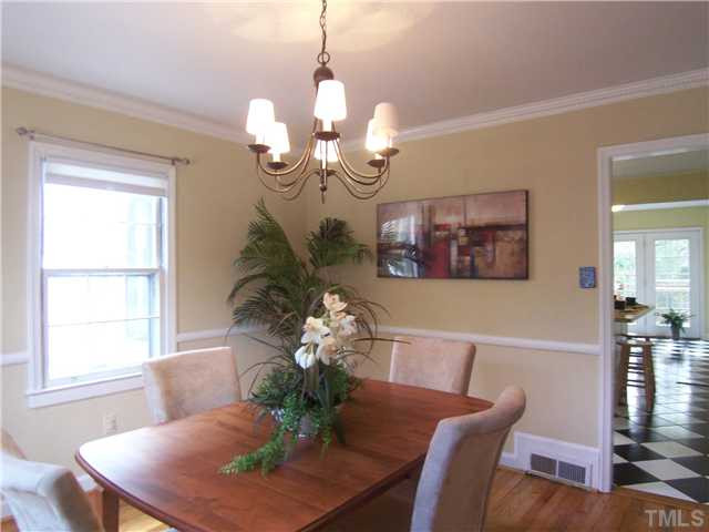 104 West Whitaker Mill Road Raleigh, NC 27608 - Photo 7 of 25 a dining room with furniture a chandelier and wooden floor