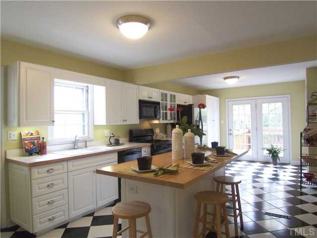 104 West Whitaker Mill Road Raleigh, NC 27608 - Photo 8 of 25 a kitchen with a sink cabinets and window